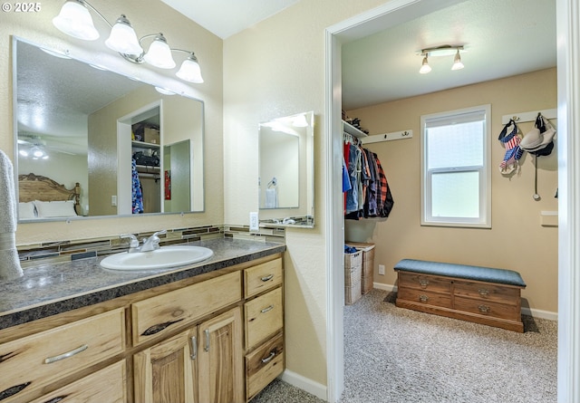 40211 Deerhorn Rd, Springfield, OR 97478 - bathroom featuring vanity, a walk in closet, and baseboards