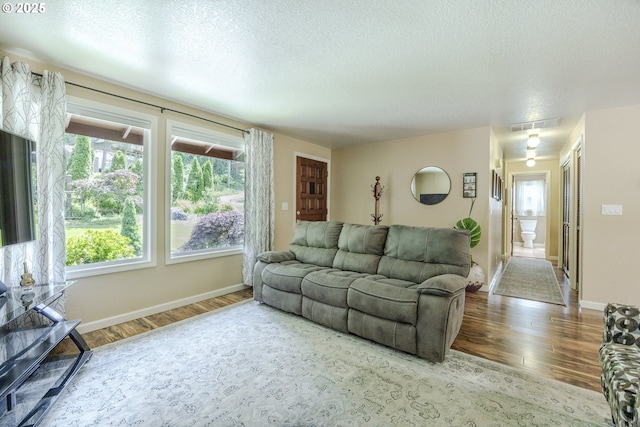 40211 Deerhorn Rd, Springfield, OR 97478 - living area featuring wood finished floors, baseboards, and a textured ceiling