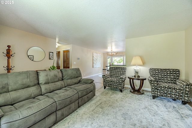 40211 Deerhorn Rd, Springfield, OR 97478 - carpeted living room featuring a chandelier, baseboards, and a textured ceiling