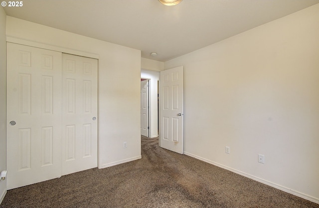 806 NW 15th Ave, Battle Ground, WA 98604 - unfurnished bedroom featuring dark carpet, a closet, and baseboards