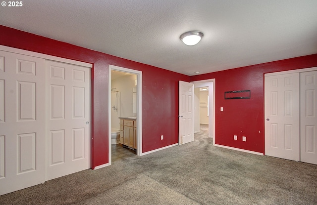 806 NW 15th Ave, Battle Ground, WA 98604 - unfurnished bedroom with carpet, a closet, a textured ceiling, ensuite bath, and baseboards