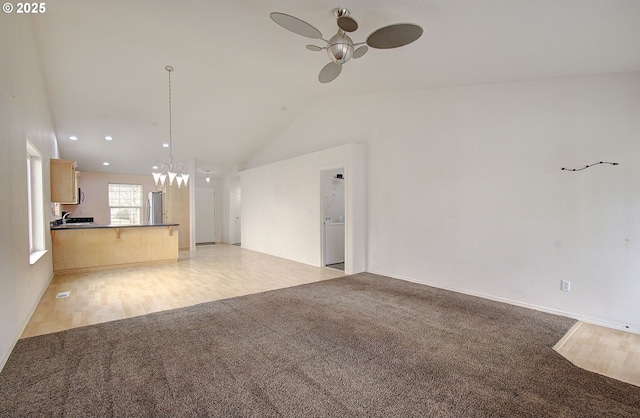 806 NW 15th Ave, Battle Ground, WA 98604 - unfurnished living room with light colored carpet, a ceiling fan, lofted ceiling, a chandelier, and recessed lighting