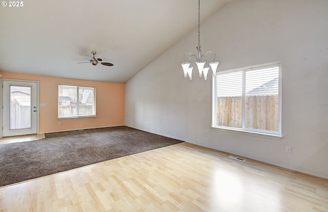 806 NW 15th Ave, Battle Ground, WA 98604 - unfurnished room with lofted ceiling, wood finished floors, a ceiling fan, a chandelier, and baseboards