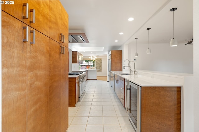 1940 SW 71st Ave, Portland, OR 97225 - kitchen featuring stainless steel stove, a sink, wine cooler, brown cabinetry, and recessed lighting
