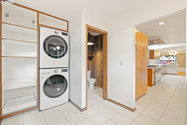 1940 SW 71st Ave, Portland, OR 97225 - laundry area with estacked washer and dryer, a chandelier, light tile patterned floors, baseboards, and recessed lighting