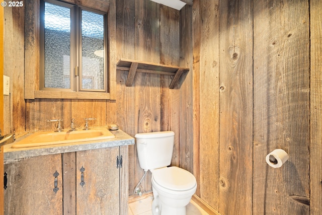 1940 SW 71st Ave, Portland, OR 97225 - half bath with toilet, wood walls, tile patterned floors, and vanity
