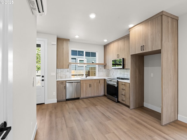 1580 NE 52nd Ave Unit 4, Portland, OR 97213 - kitchen featuring appliances with stainless steel finishes, a wall unit AC, light countertops, backsplash, and recessed lighting