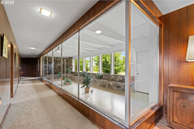 53767 E Honeyman Rd, Scappoose, OR 97056 - hall with wood walls, light carpet, and a textured ceiling