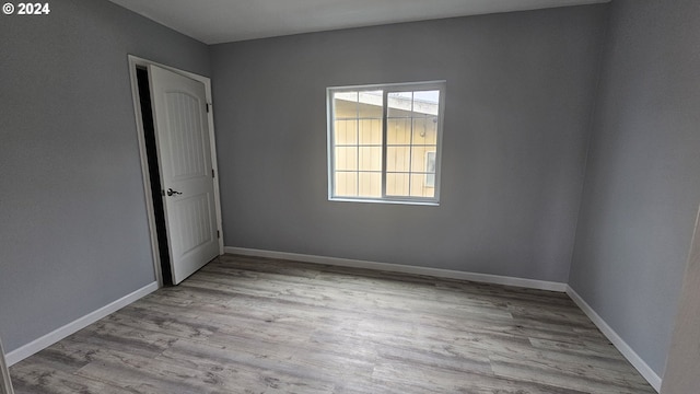 spare room with light wood-type flooring