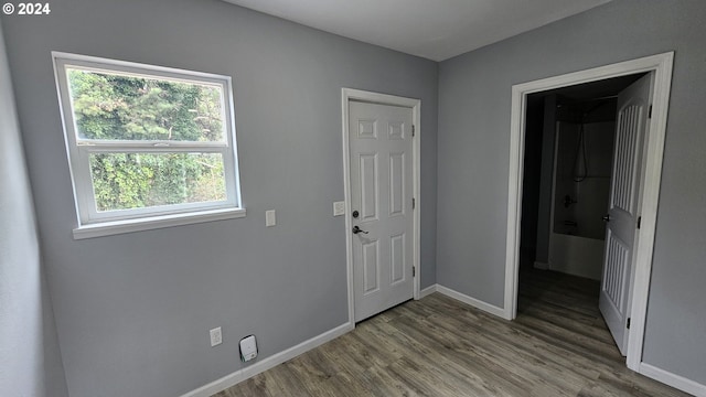 interior space with plenty of natural light and hardwood / wood-style floors