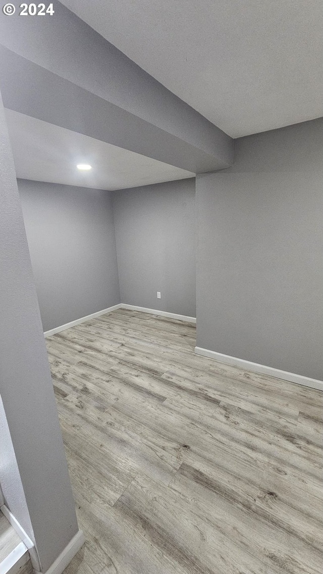 unfurnished room with light wood-type flooring