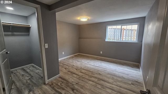 unfurnished bedroom with a closet and dark hardwood / wood-style floors