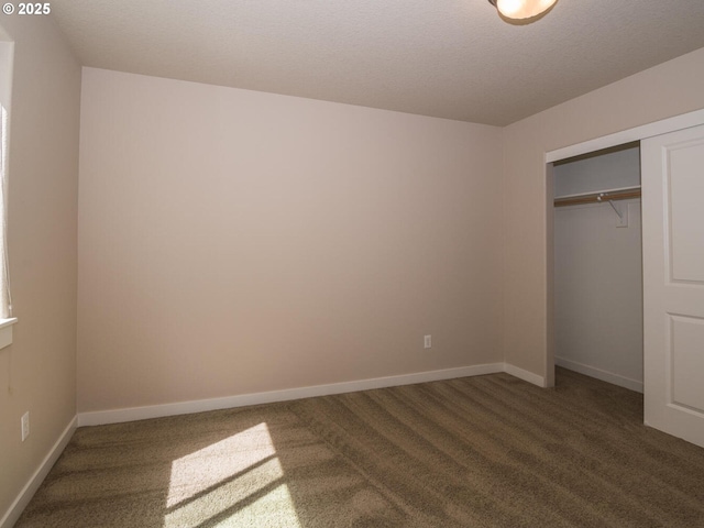 unfurnished bedroom featuring a closet, baseboards, and carpet floors