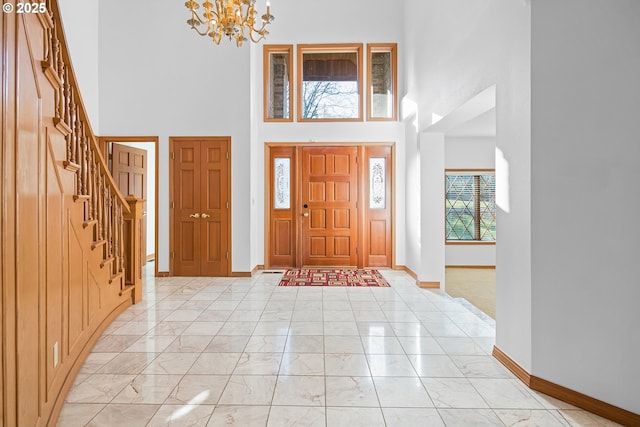 entryway with a towering ceiling and an inviting chandelier