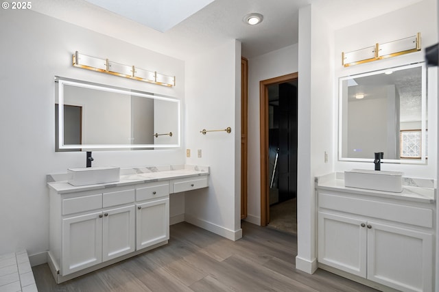 bathroom with hardwood / wood-style flooring and vanity