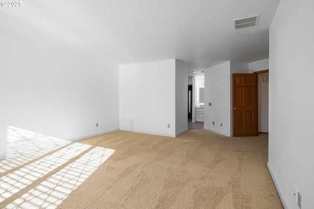 interior space with light carpet and a textured ceiling