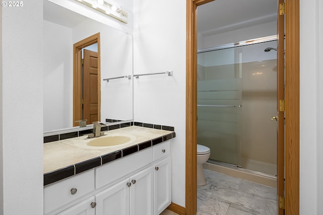 bathroom featuring toilet, vanity, and walk in shower