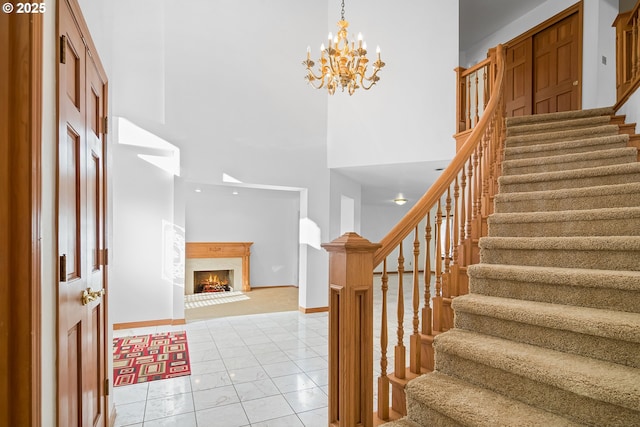 entrance foyer featuring light tile patterned flooring, a notable chandelier, and a high ceiling