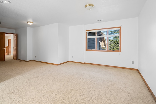 carpeted spare room featuring a textured ceiling