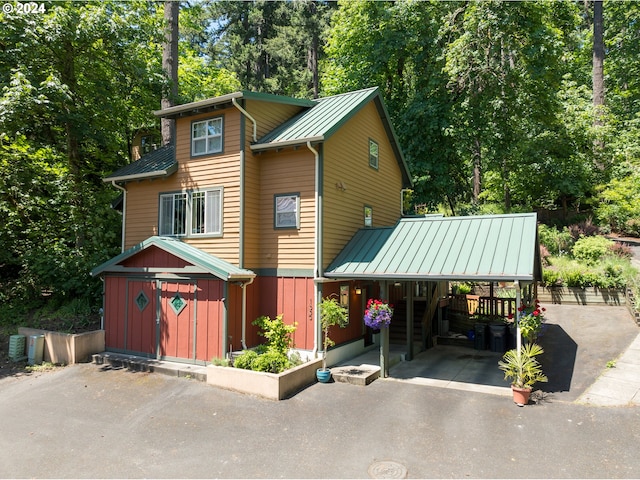 1650 Leatherwood Dr, Eugene, OR 97405 - view of front of home with metal roof, a standing seam roof, driveway, and a carport