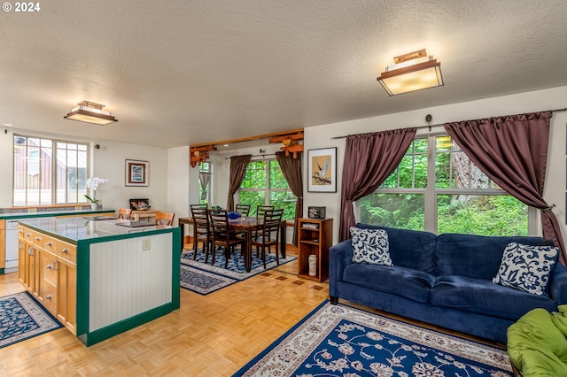 1650 Leatherwood Dr, Eugene, OR 97405 - kitchen with a textured ceiling, a kitchen island, and a wealth of natural light