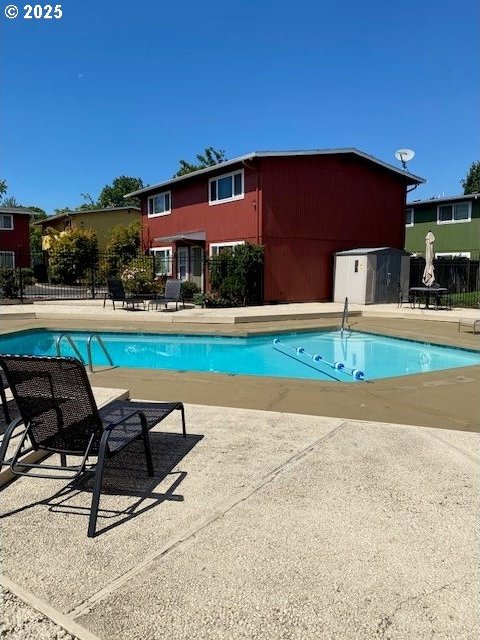 pool with fence and a patio