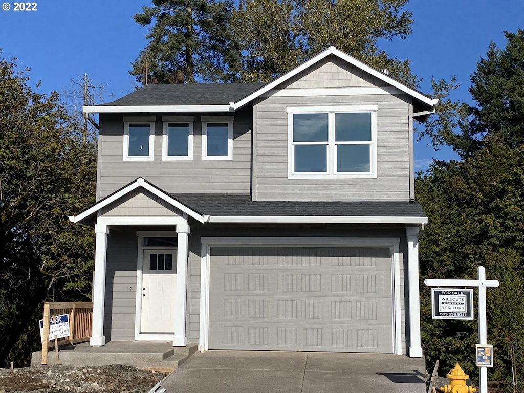 1524 S Camille Pl, Newberg, OR 97132 - view of front of house featuring an attached garage, concrete driveway, and roof with shingles