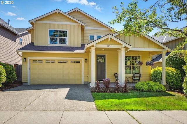 418 SW 140th Ave, Beaverton, OR 97006 - view of front facade with board and batten siding, a porch, driveway, an attached garage, and a front yard