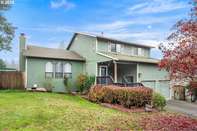 traditional-style home featuring driveway, a front lawn, a garage, covered porch, and fence