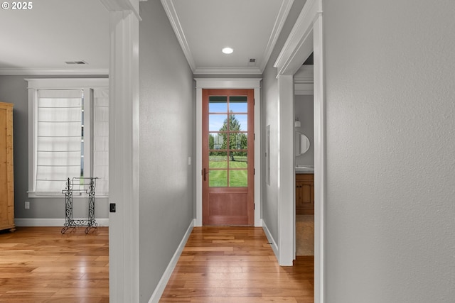 doorway to outside with crown molding and light hardwood / wood-style flooring