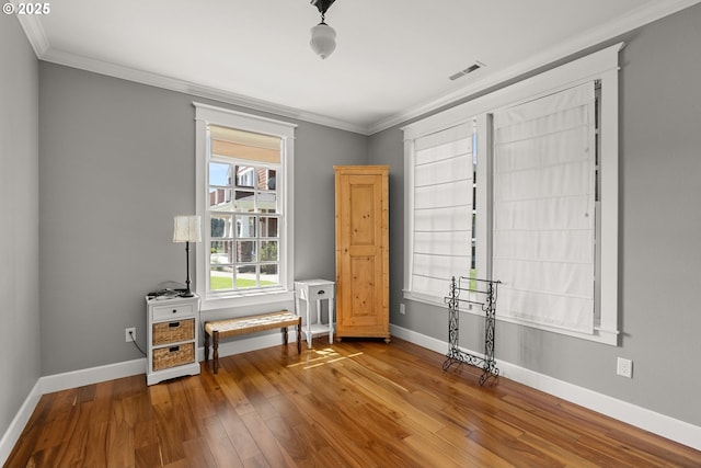 interior space with hardwood / wood-style flooring and crown molding