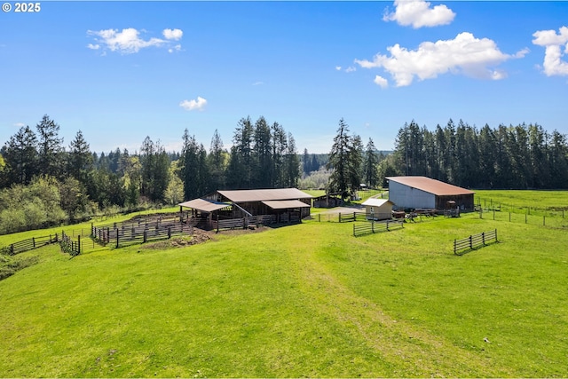 view of yard featuring a rural view and an outdoor structure