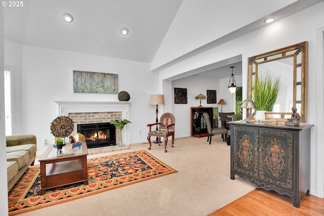 12909 SW Jacob Ct, Portland, OR 97224 - living room with a brick fireplace, lofted ceiling, recessed lighting, and baseboards