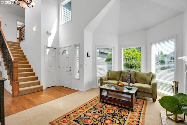 12909 SW Jacob Ct, Portland, OR 97224 - entrance foyer featuring carpet floors, high vaulted ceiling, stairway, baseboards, and a chandelier