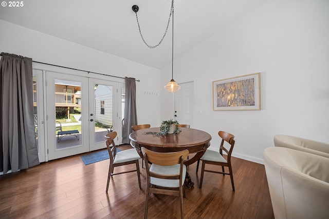 dining area featuring baseboards, french doors, high vaulted ceiling, and dark wood-type flooring