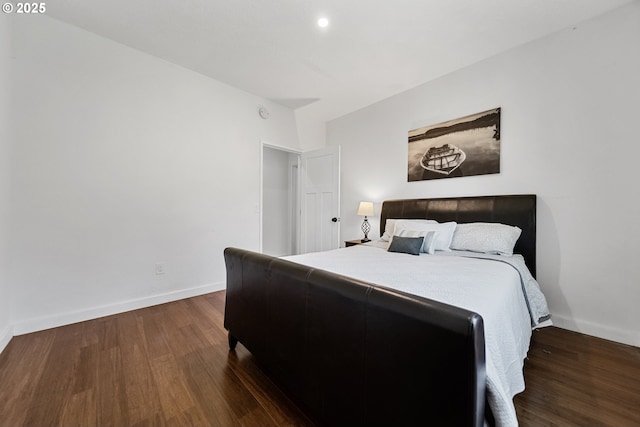 bedroom with baseboards and wood finished floors