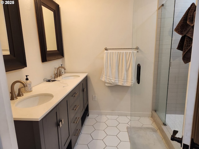 bathroom featuring a sink, tile patterned floors, a shower stall, and double vanity