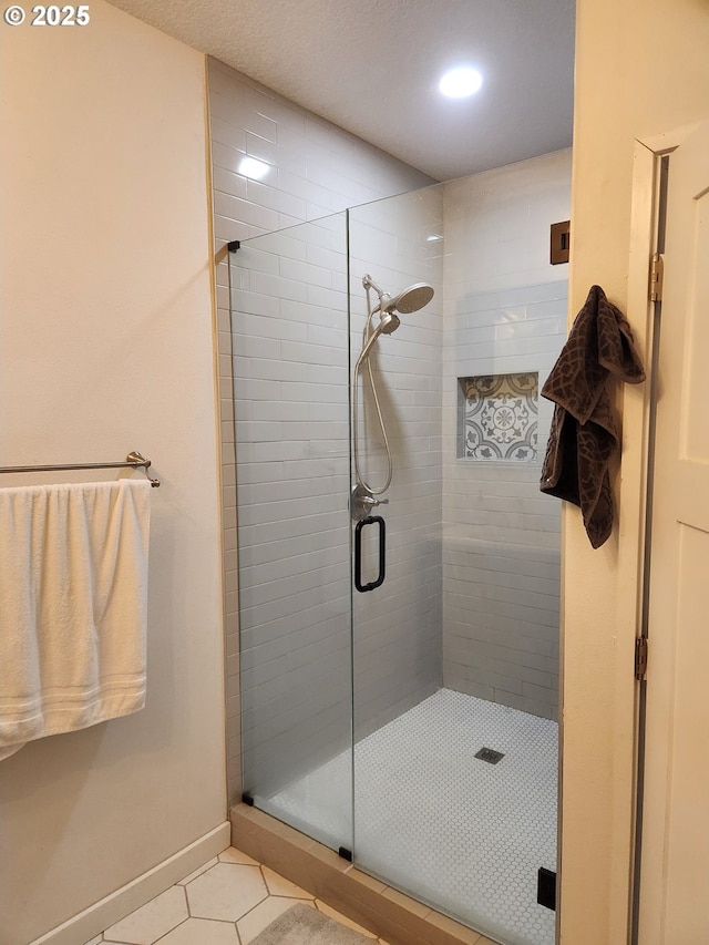 full bath featuring baseboards, tile patterned floors, a stall shower, and recessed lighting