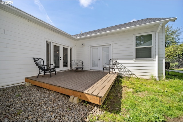 rear view of property featuring french doors, a shingled roof, and a deck