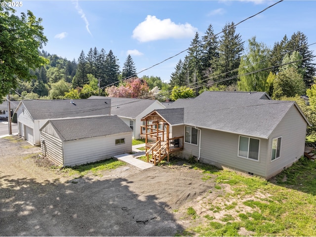 view of front of property with crawl space and roof with shingles