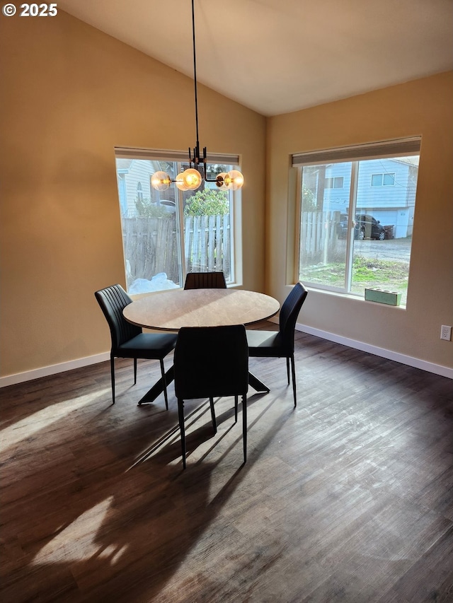 dining space with a chandelier, baseboards, vaulted ceiling, and dark wood-type flooring
