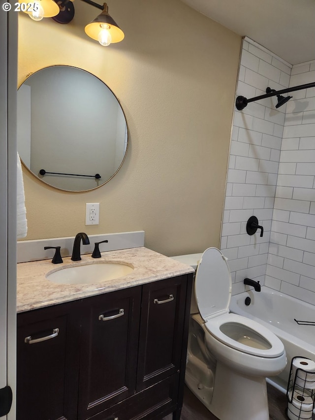 bathroom featuring vanity, bathing tub / shower combination, and toilet