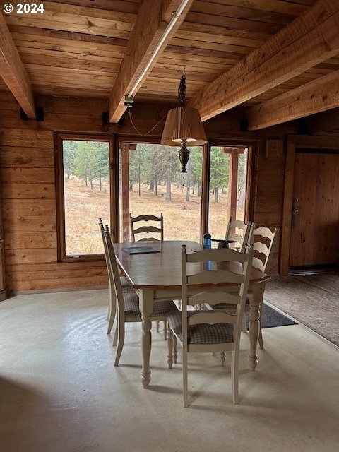 60327 Lower Divide Rd, Joseph, OR 97846 - dining room featuring wood walls and wooden ceiling with exposed beams