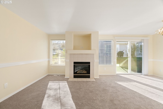 unfurnished living room featuring a fireplace and light colored carpet