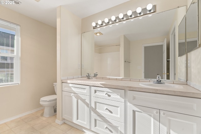 bathroom with tile patterned floors, vanity, toilet, and a shower