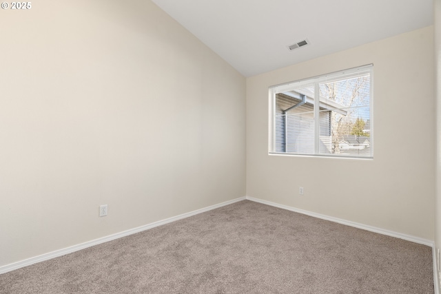 unfurnished room with lofted ceiling and light colored carpet