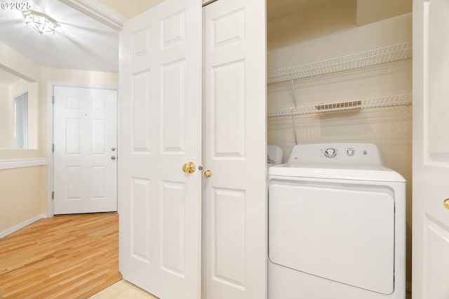 laundry room featuring washer / clothes dryer and light hardwood / wood-style flooring