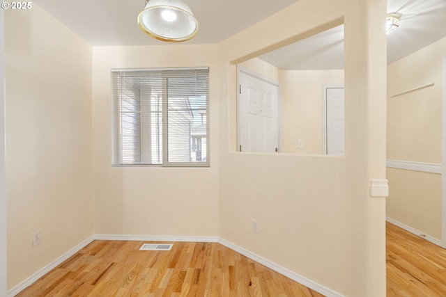 empty room with hardwood / wood-style floors