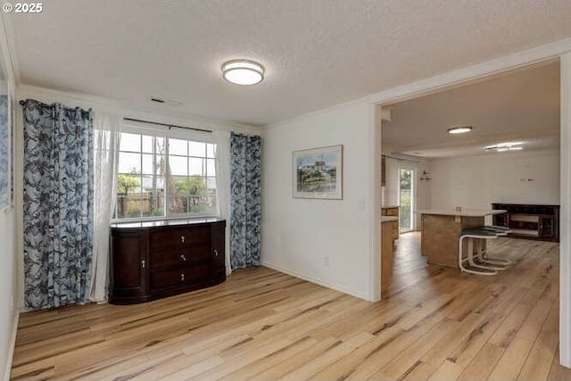 2040 Spruce Ave, Woodland, WA 98674 - spare room featuring light wood-style floors, crown molding, baseboards, and a textured ceiling