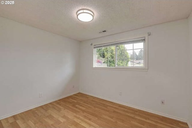 2040 Spruce Ave, Woodland, WA 98674 - empty room with light wood-type flooring, baseboards, and a textured ceiling